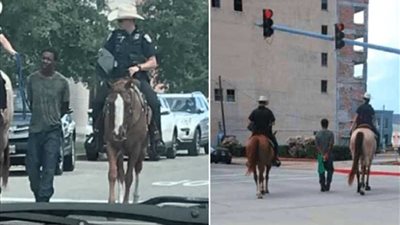 ضابط شرطة أمريكي يركب حصانًا ويقود رجلًا أسود مكبل اليدين بحبل (صور)