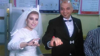 عروسان يدليان بصوتيهما في لجنة بالمنصورة